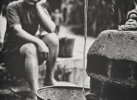 Woman Waits For A Bucket To Fill From A Standpipe - Silver Prize At The Hong Kong International Salon Of Photography | Photographer: Chung Man Lurk (1959)